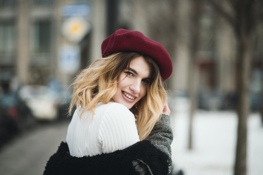 Smiling Woman Wearing Red Hat during Snowy Day