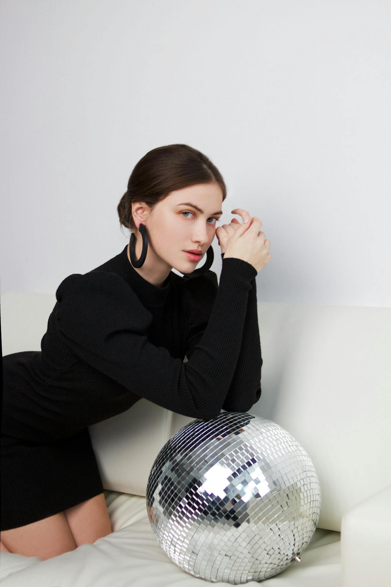 Young Woman Posing with Disco Ball