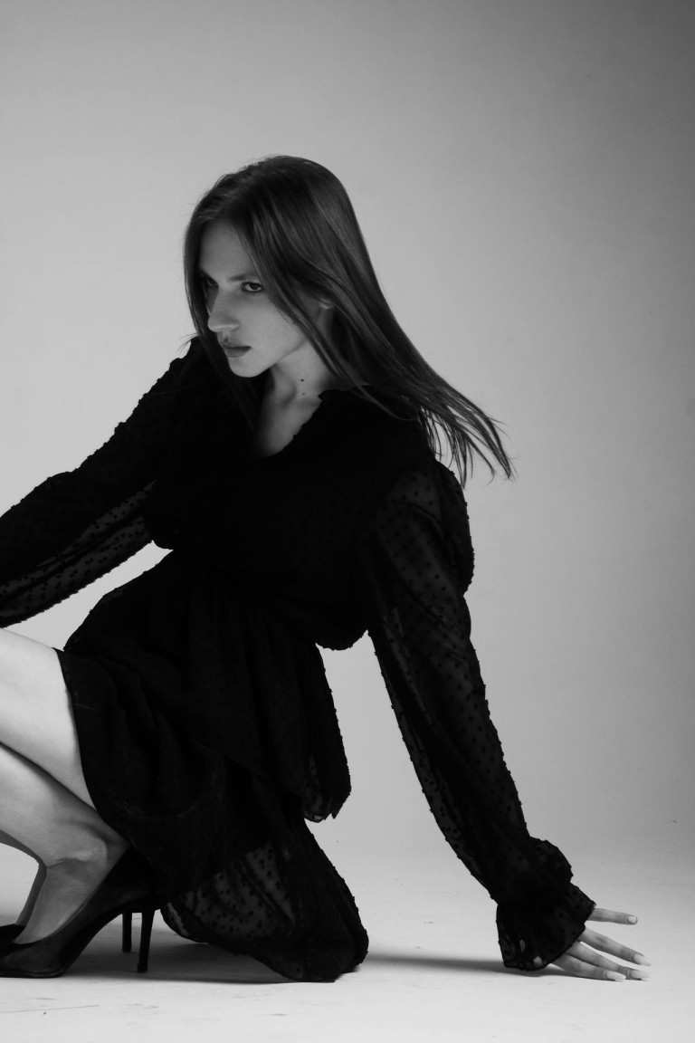 Woman Sitting in Black Clothes