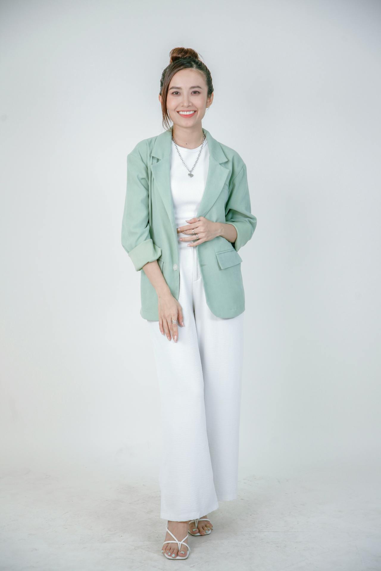 Fashionable Woman in Green Blazer Smiling