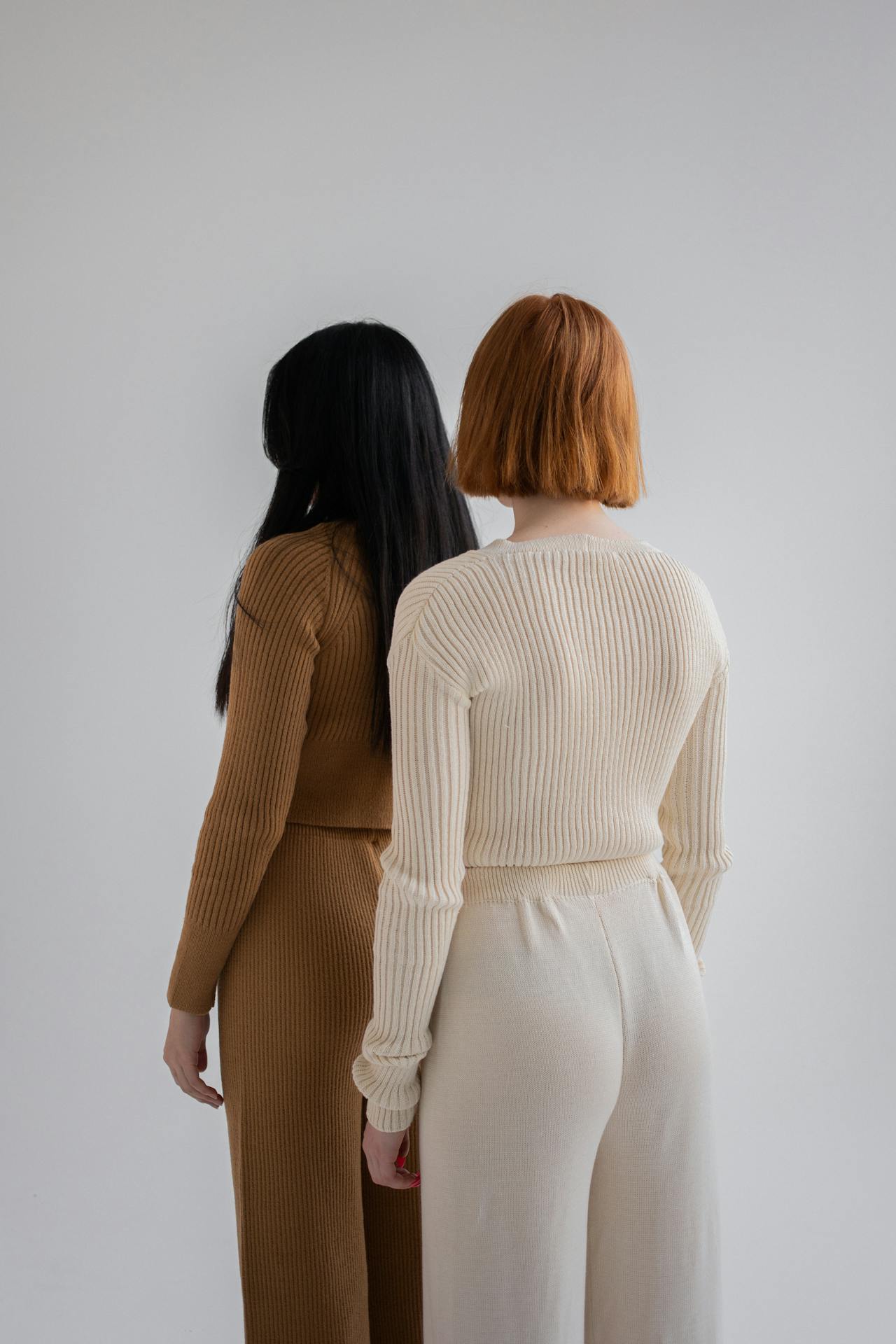Women dressed in knitted sweaters and pants in studio