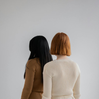 Women dressed in knitted sweaters and pants in studio